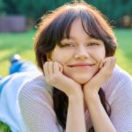 Headshot outdoor portrait of young female 18 years old