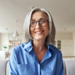 Smiling mature older woman looking at camera, webcam headshot.